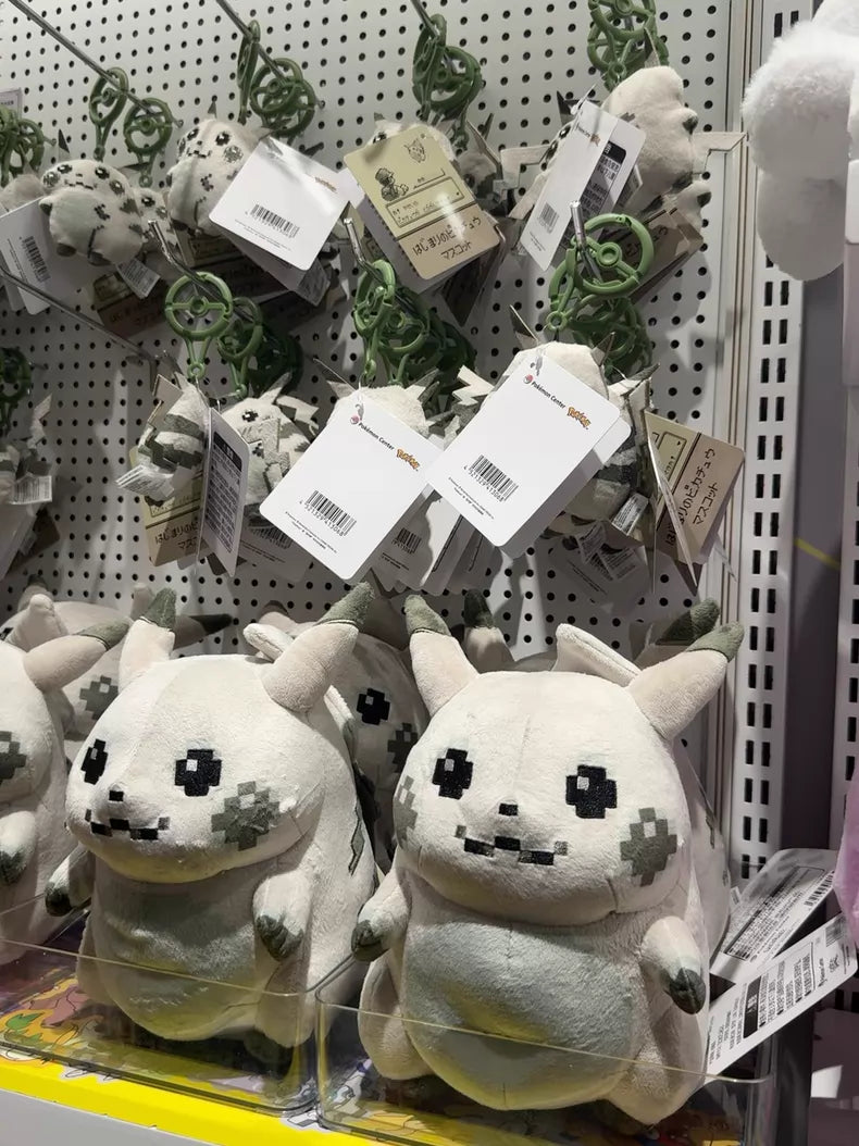 ZoDoll’s Retro 8-Bit Pikachu of Beginnings Plush – Classic Chunky Pokémon 30th Anniversary Pikachu Plush Toy is displayed on a store shelf with price tags, featuring a pixelated, stylized animal design.