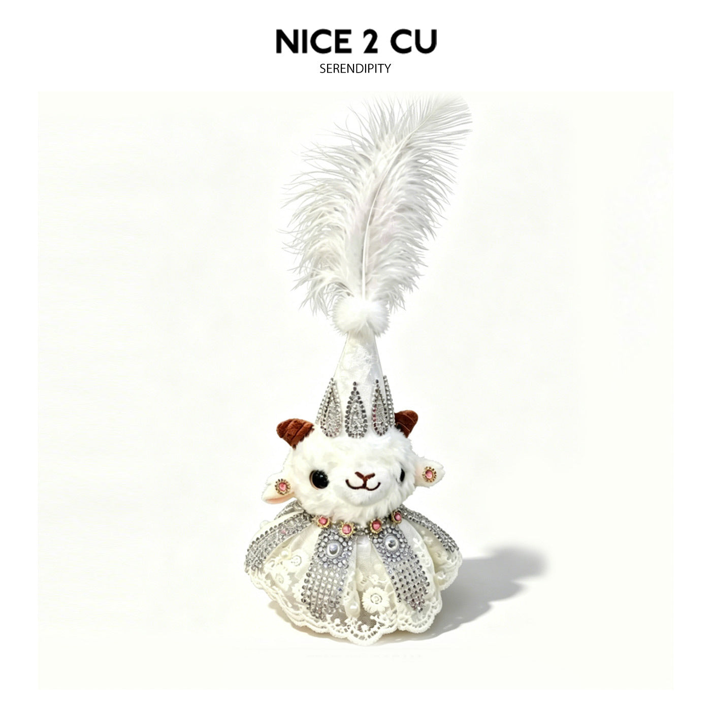 Plush lamb figurine with tall white feather headpiece and silver rhinestone detailing on white outfit