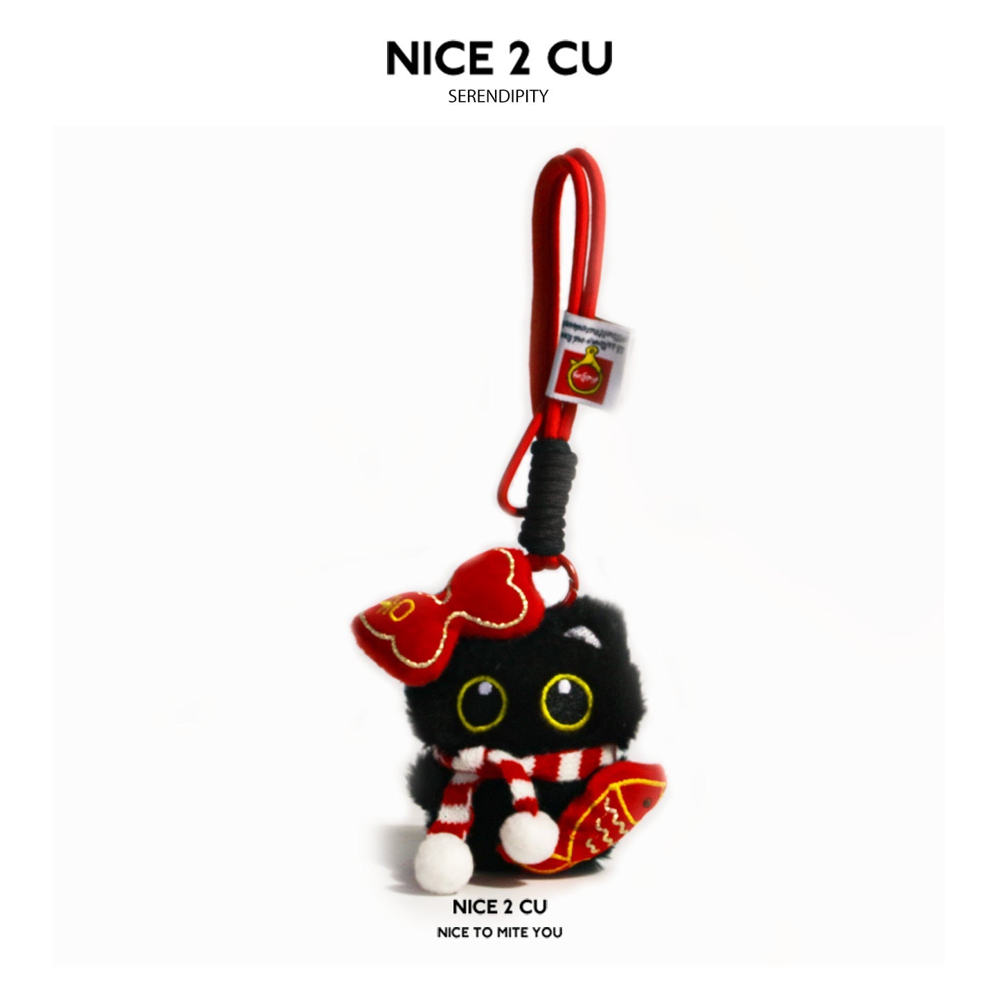 Black cat plush charm holding a red fish ornament, wearing a striped scarf and red bow