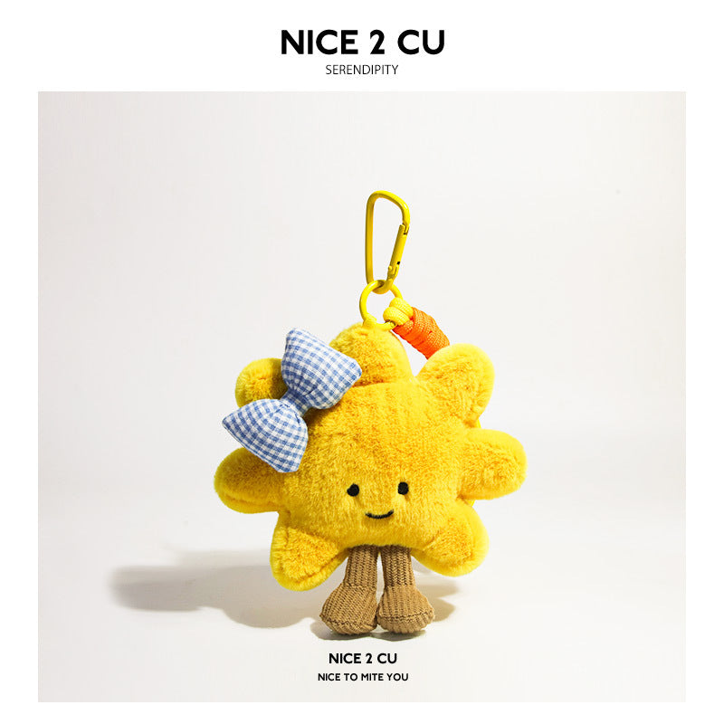 Yellow sunflower plush charm decorated with a blue checkered bow and yellow strap