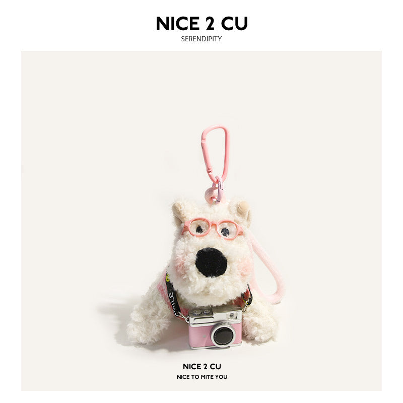 White Westie plush charm with pink glasses and pale pink sweater holding pink camera accessory, pink carabiner clip