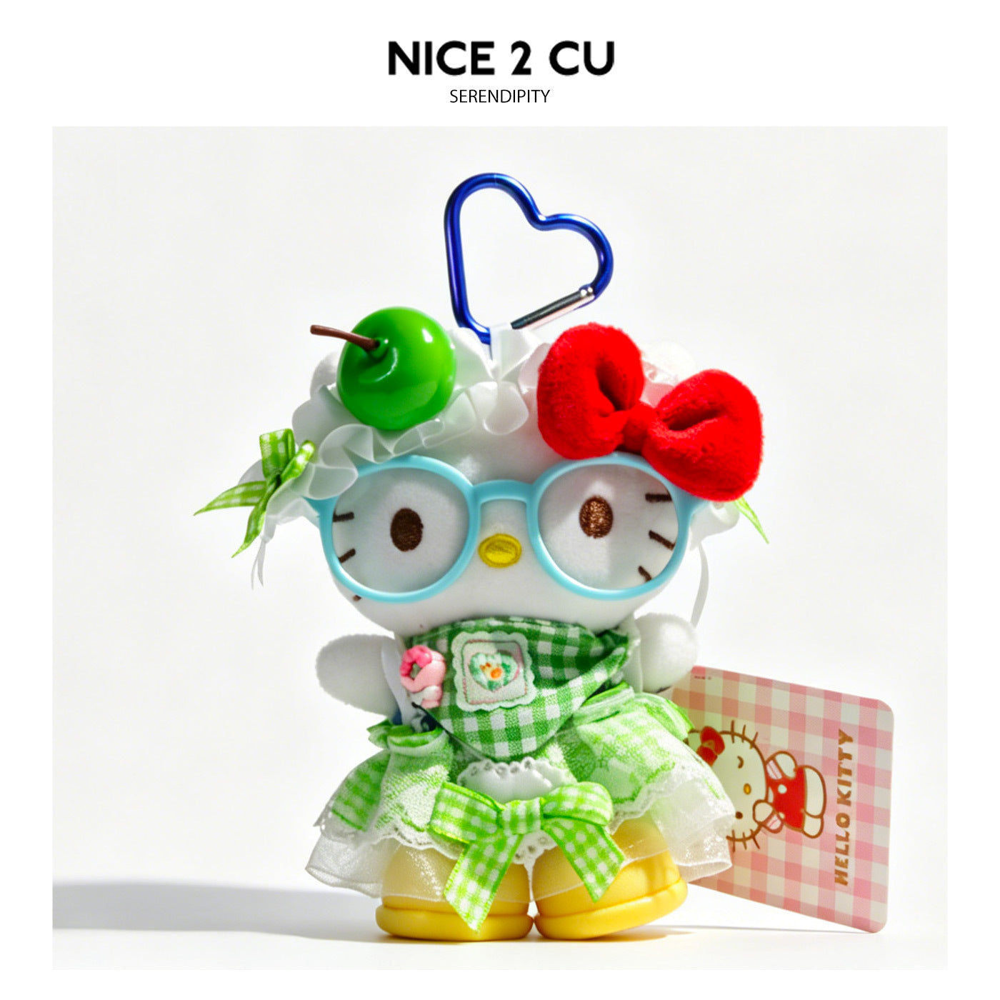 Hello Kitty plush charm with green checkered dress, apple hair decoration, blue glasses, and yellow shoes