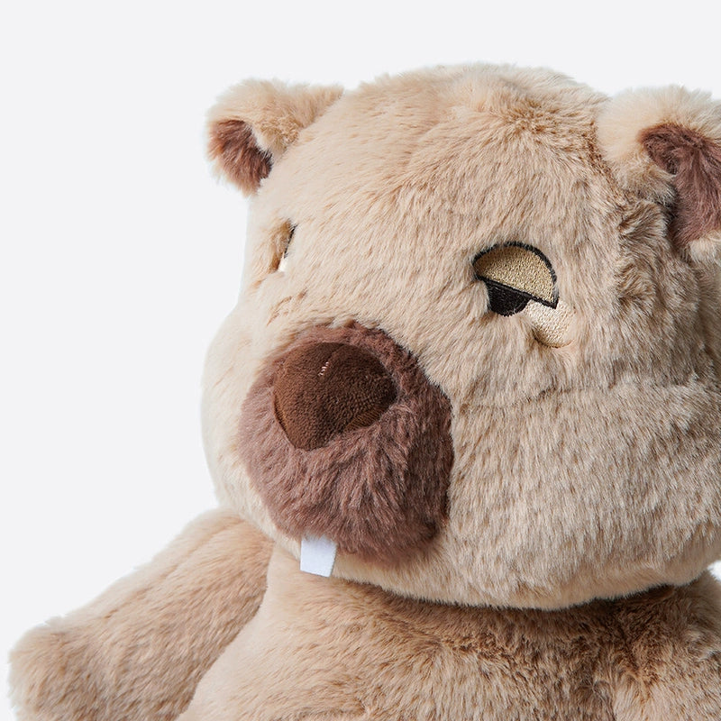 Close-up of the ZEIO Wombat Plush Toy, a 48cm large ultra-soft stuffed animal featuring light brown fur, embroidered eyes, a brown nose, a single white tooth, and an attached mini doll.