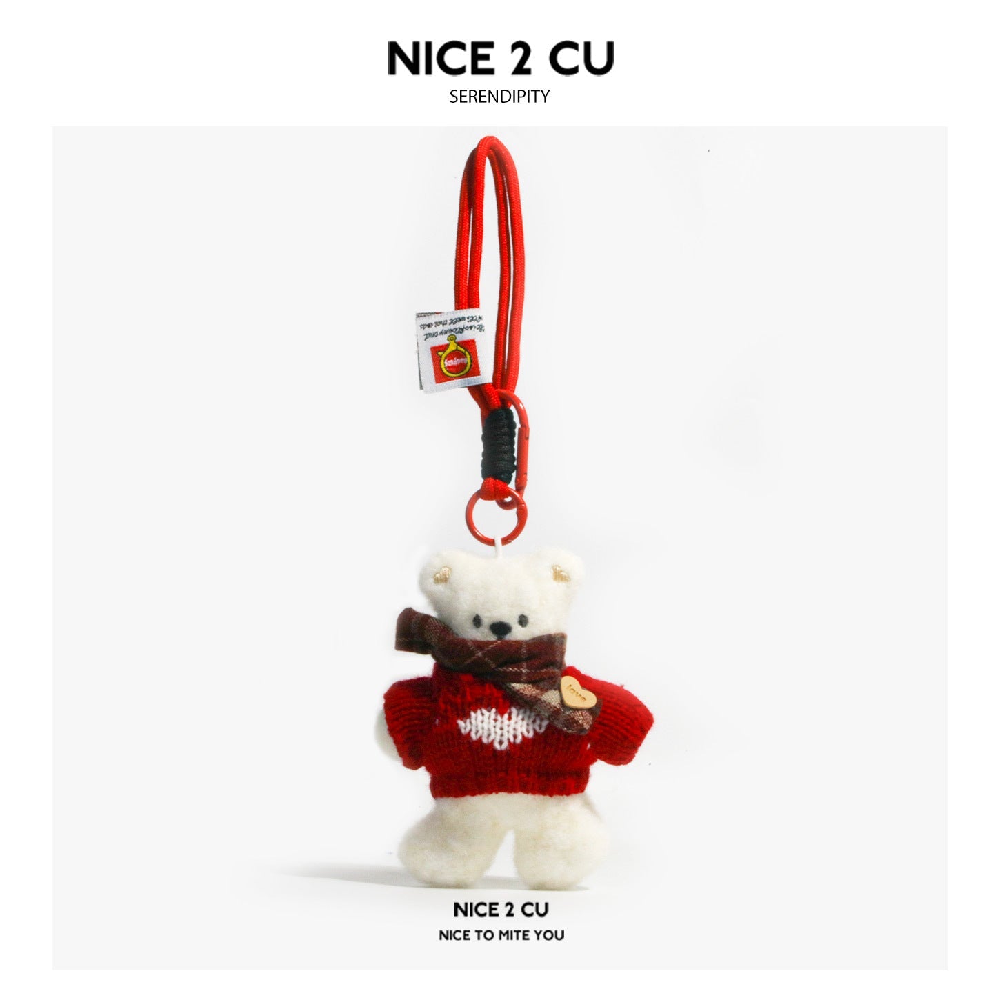 Serendipity Dirty Bear plush keychain pendant wearing a red knitted sweater with white heart motif and plaid scarf