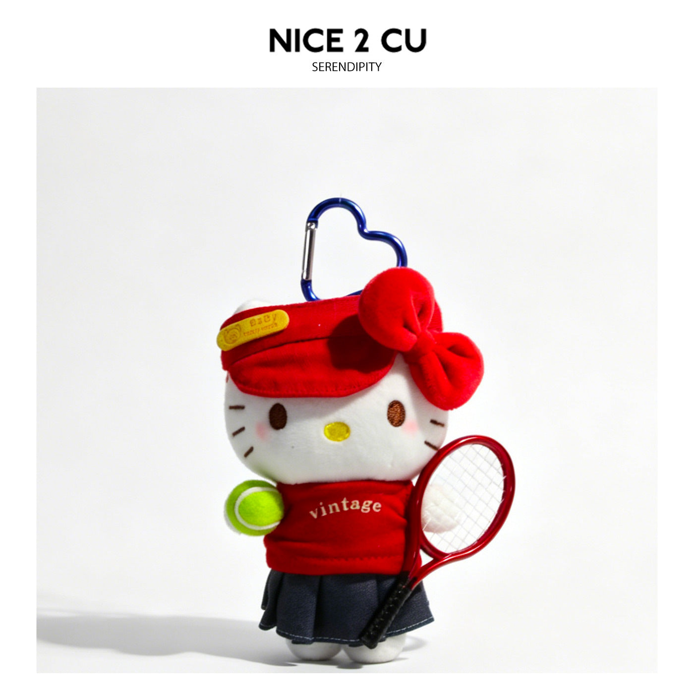 Cartoon cat plush keychain in red tennis outfit holding miniature racket and tennis ball with blue heart carabiner clip