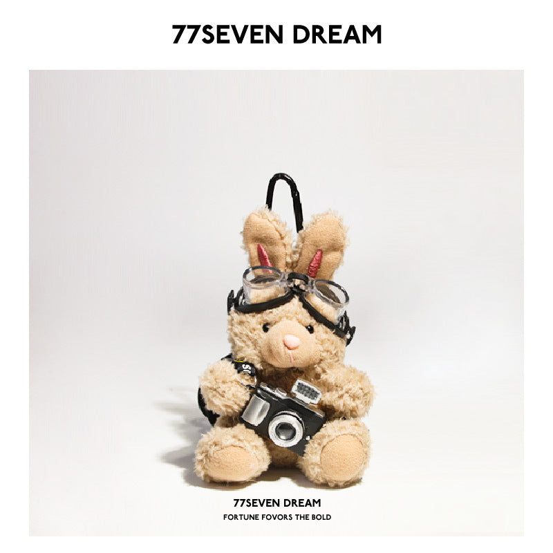 Tan brown rabbit plush keychain charm with aviator goggles and miniature black camera accessory