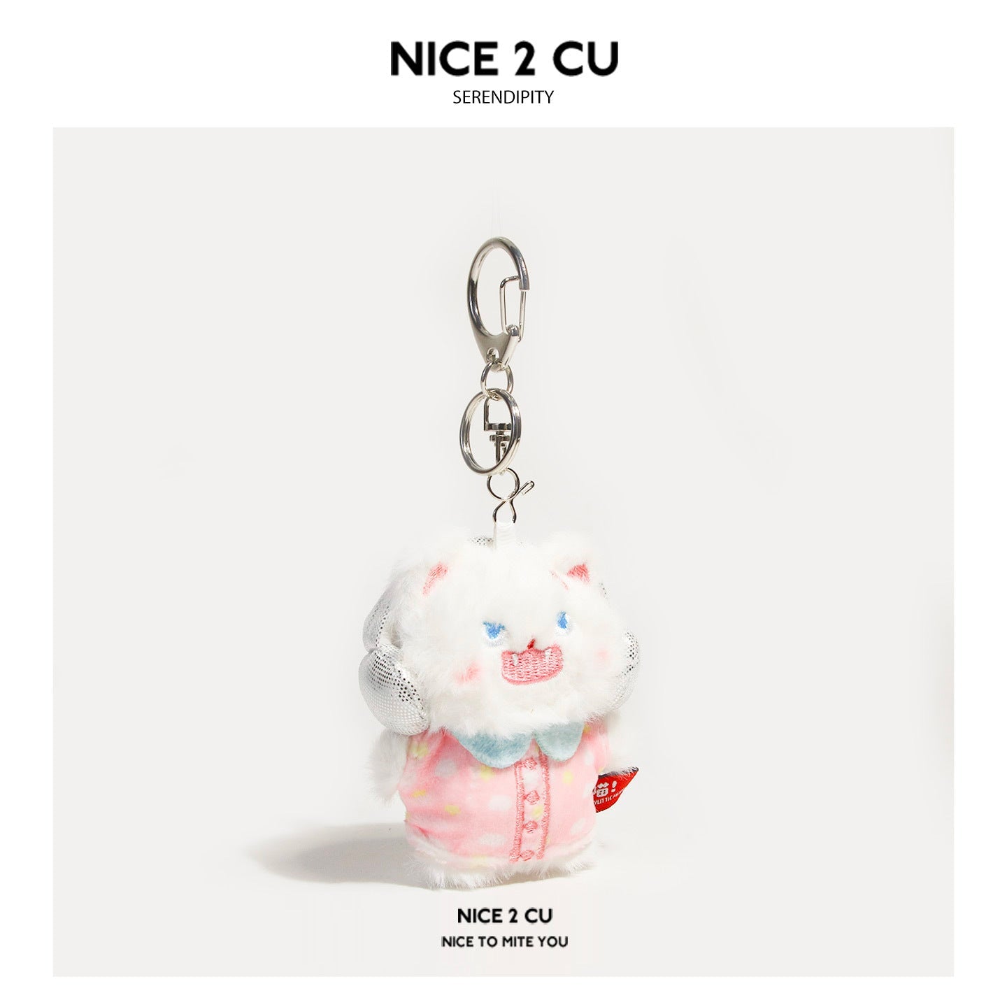 White fluffy cat plush keychain wearing pink pajamas with light blue collar and silver clasp