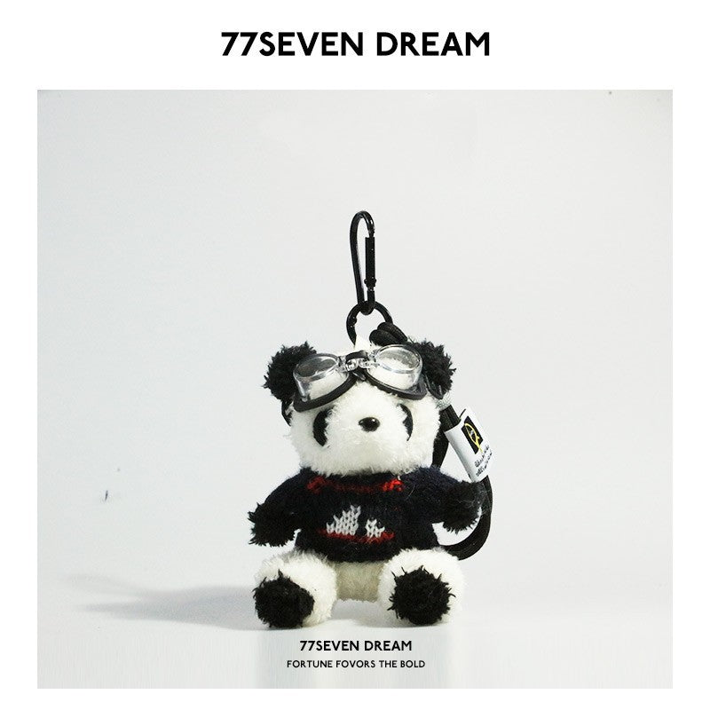 Seated panda plush charm in black knitted sweater with small decorative motif and clear goggles