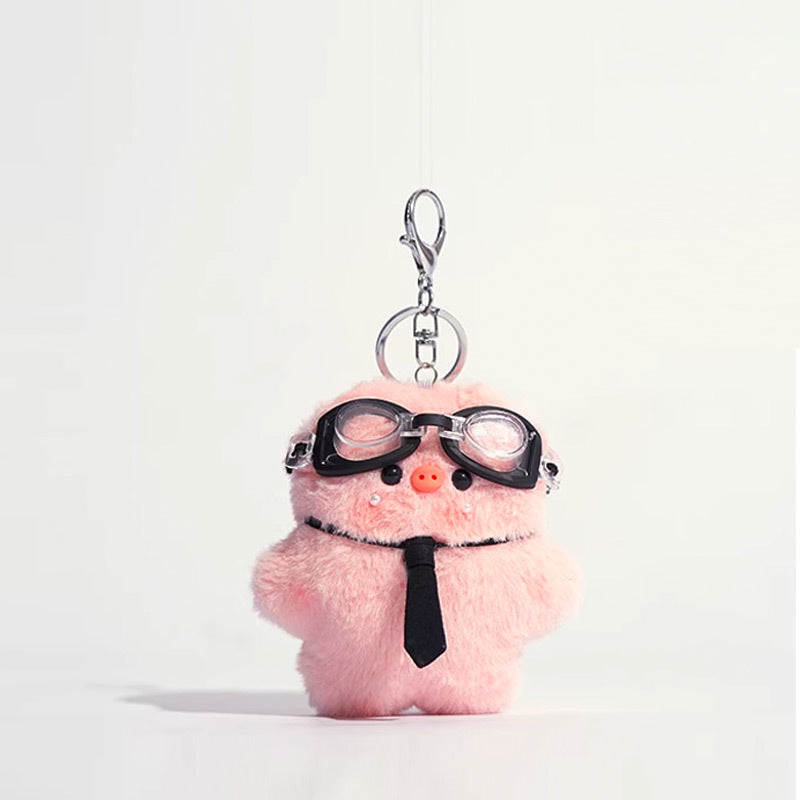 Pink plush pig keychain charm wearing black goggles on forehead and black necktie, silver lobster clasp