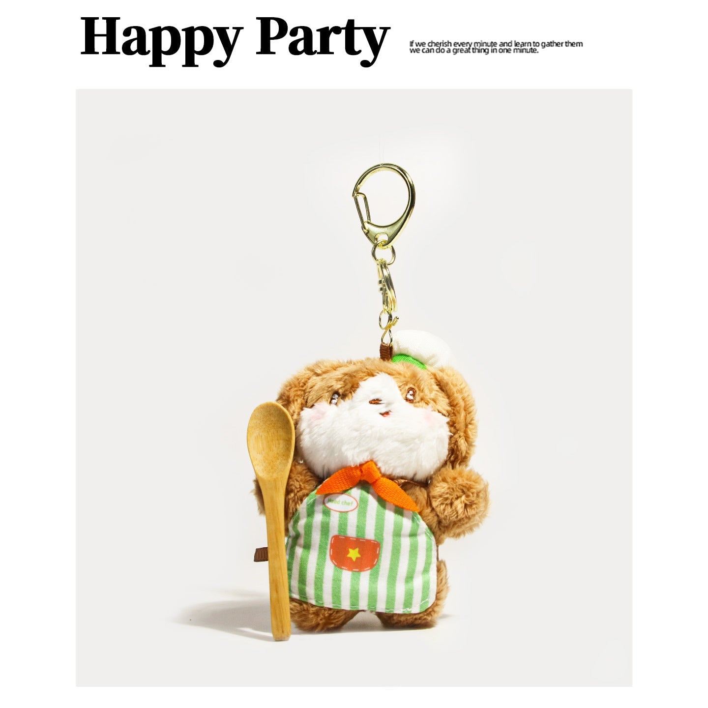 Plush dog keychain charm wearing a green and white striped chef apron, orange bow, white hat, and wooden spoon with gold clas