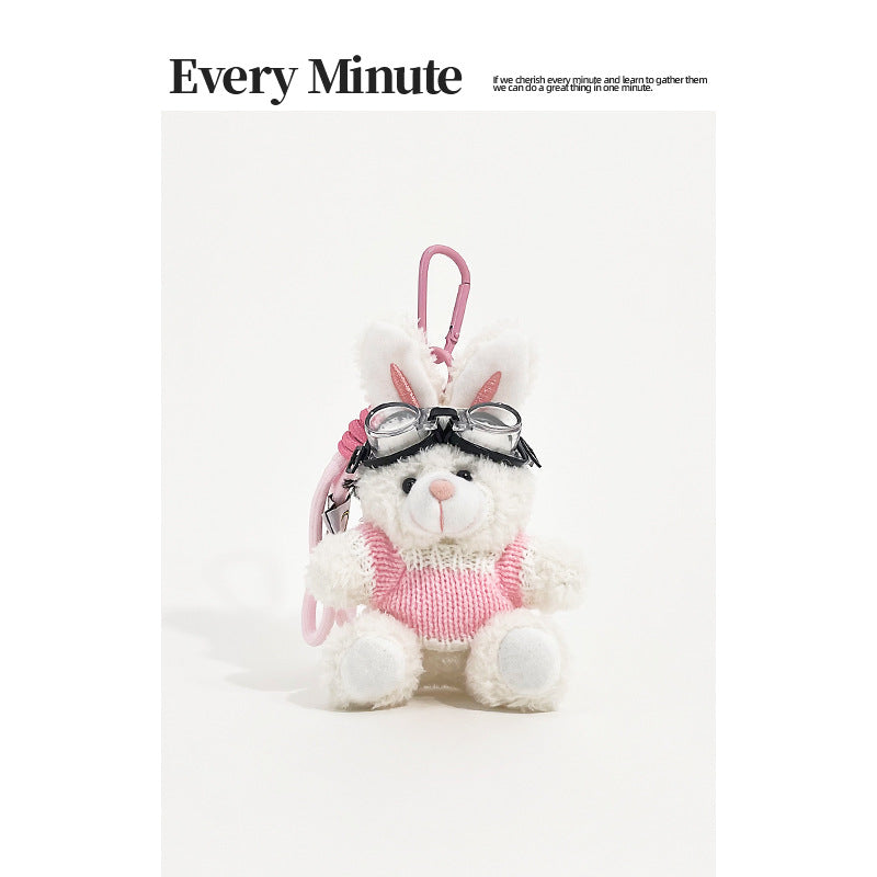 White rabbit plush keychain charm wearing aviator goggles and a pink-and-white knit sweater with pink carabiner clip