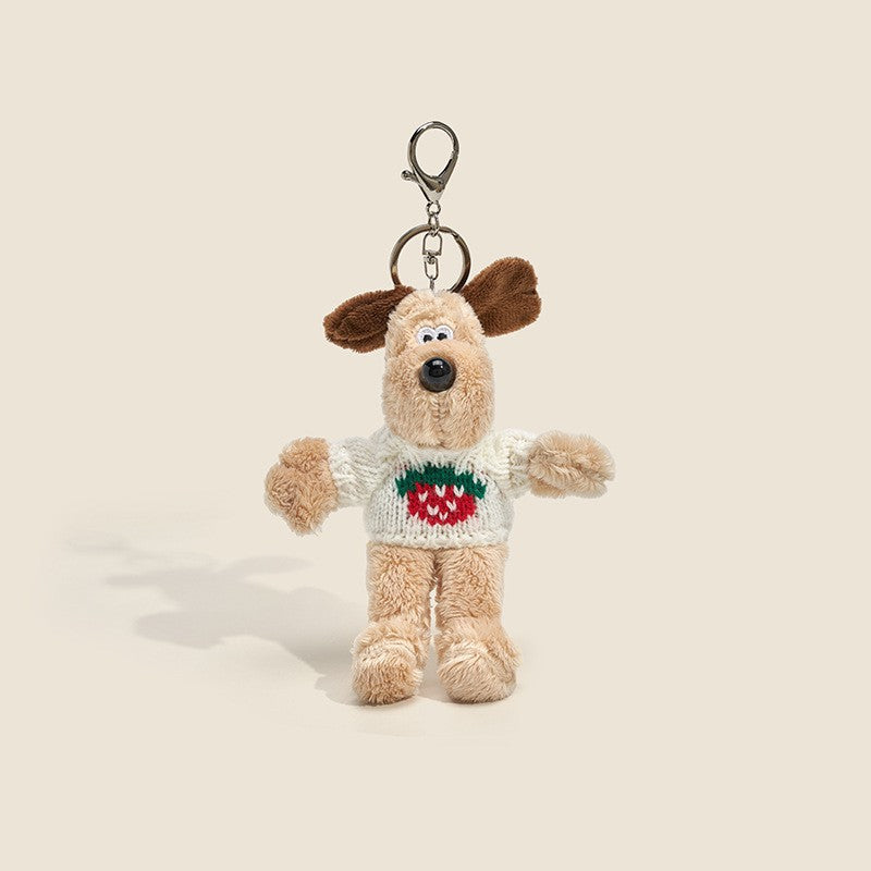 Long-fur cream dog plush charm wearing off-white sweater with strawberry graphic