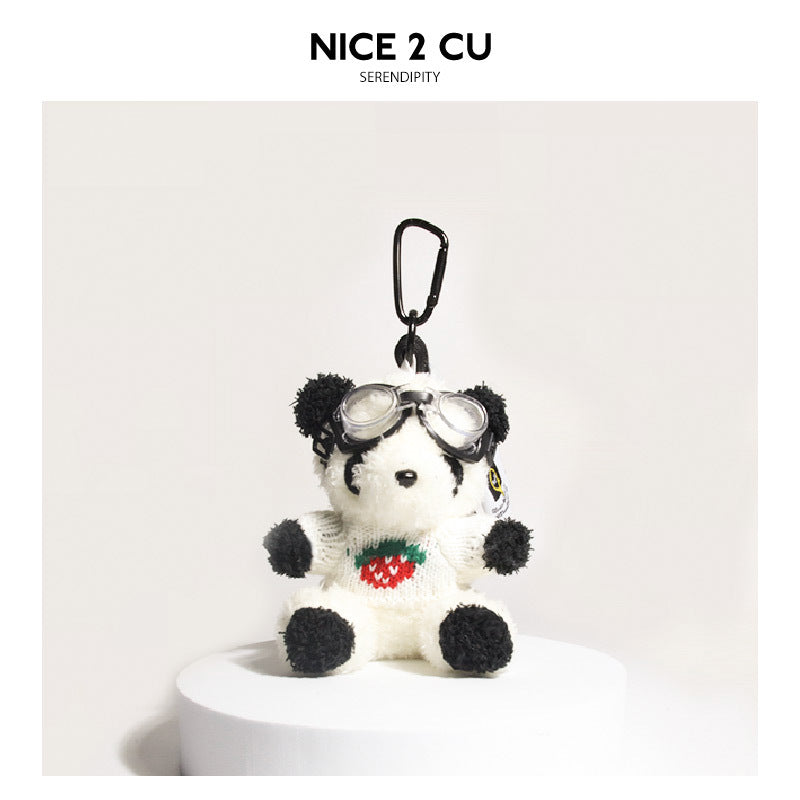 Seated panda plush keychain charm wearing white knit sweater with strawberry motif and clear aviator goggles