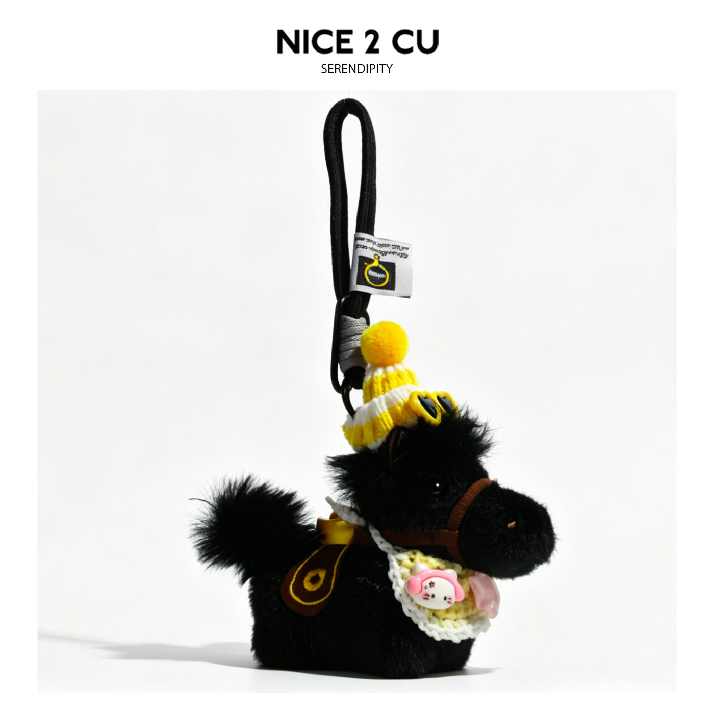 Black fluffy plush horse keychain with yellow striped knit beanie, dark mini sunglasses, cream scarf, and mustard bow