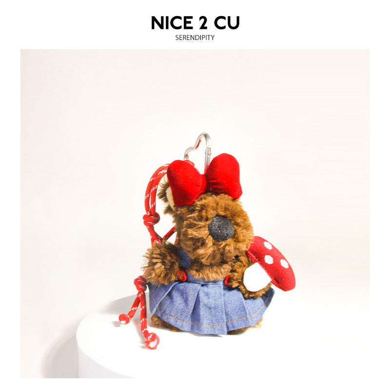 Brown terrier plush bag charm with red bow, denim skirt, red polka-dot mushroom, and red hanging cord
