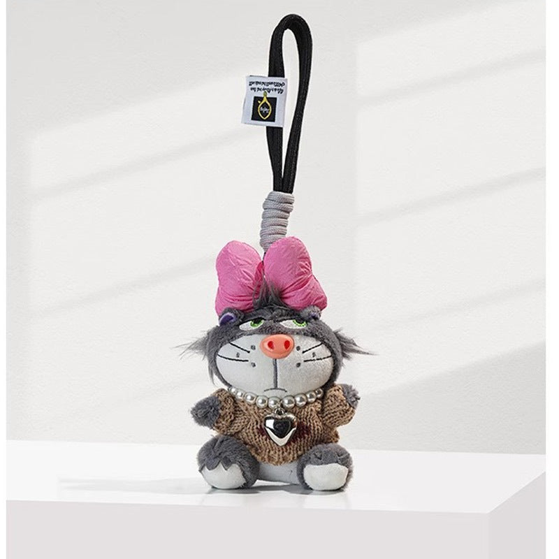 Grey cat plush charm in brown knit outfit with pink bow and silver heart pendant on bead necklace