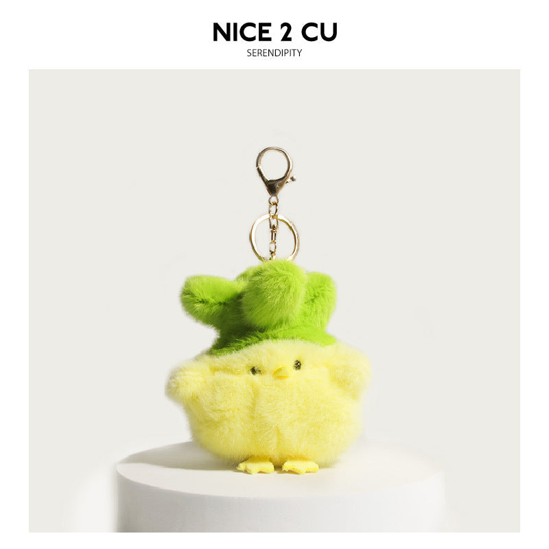 Yellow fluffy plush chick keychain charm wearing an oversized bright green bucket hat with gold lobster clasp