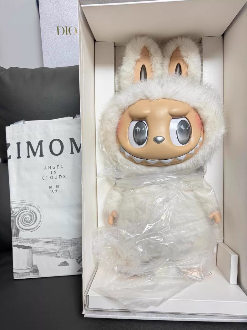 The POP MART Labubu Angel in Clouds 58cm Designer Plush Doll – THE MONSTERS Premium Limited Edition features large eyes, animal-like ears, a fluffy white outfit, and comes boxed with a monochrome book for collectors.