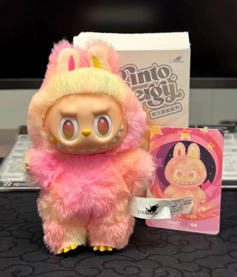 The Labubu “Loyalty” Plush Keychain from POP MART’s Big Into Energy series features an angry plush in a pink tie-dye bunny suit, displayed with its box and character card—a fun collectible and bag charm for fans.