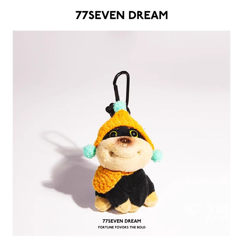 Plush dog charm with orange knitted hat, orange scarf accessory, and mint pompoms