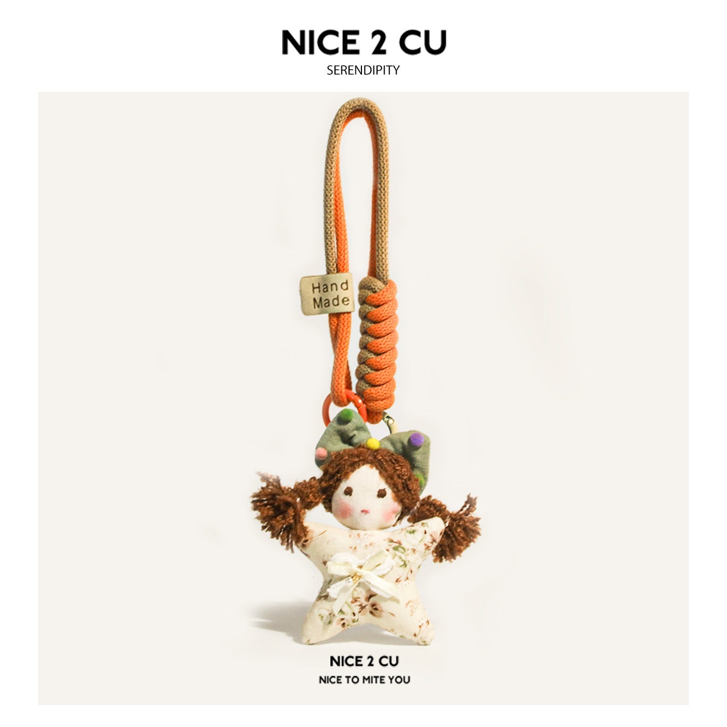 Handmade-style star girl plush charm in orange and beige with colorful dotted bow, brown pigtails, and orange braided cord lo