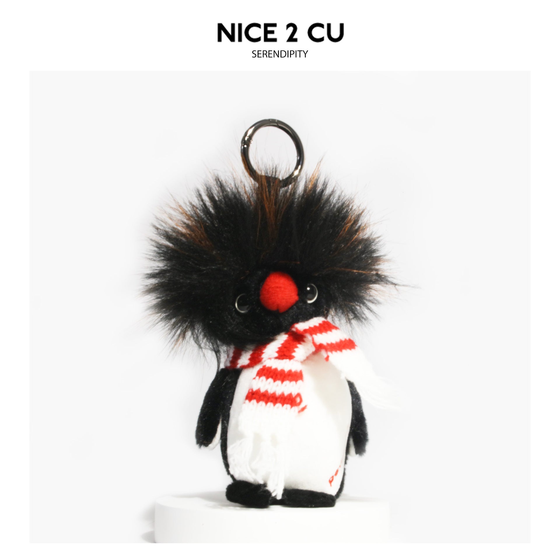 Fluffy penguin plush charm with red-and-white striped fringed scarf and metal hanging loop