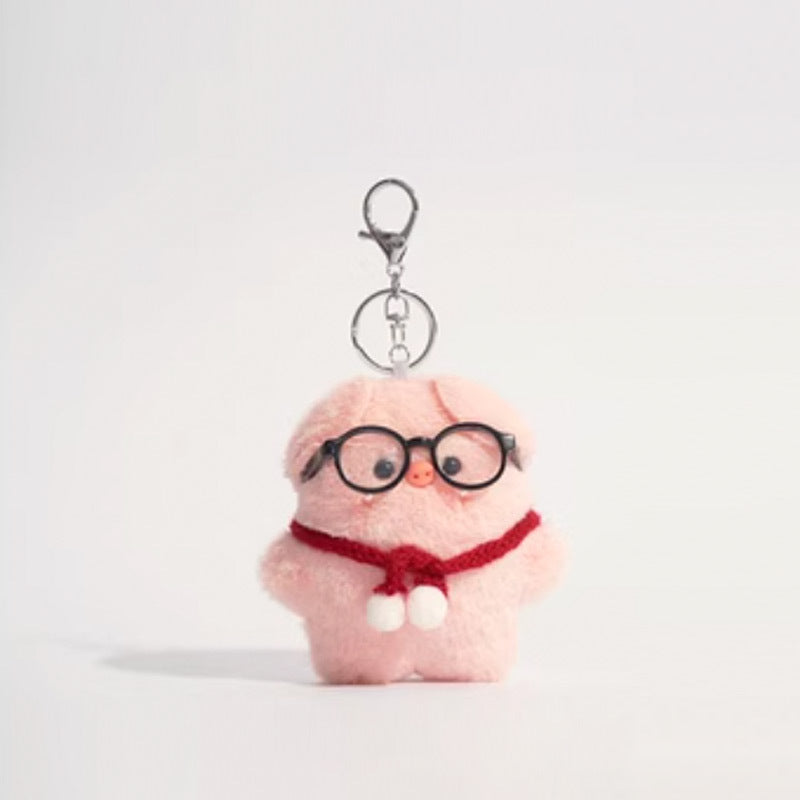 Pink plush pig keychain wearing round black glasses and red scarf with white pom-poms, silver clip
