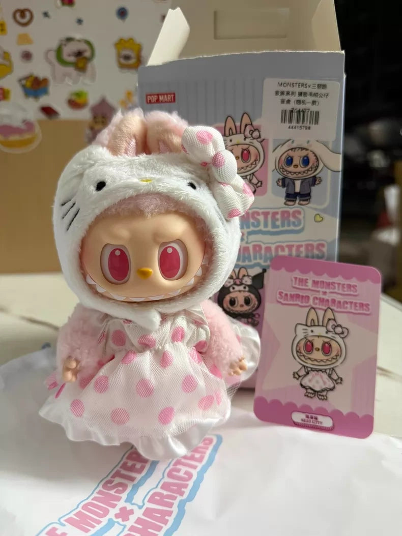 The POP MART LABUBU Hello Kitty and Friends Series Hello Kitty Plush Pendant Figure features a large-eyed doll in a pink polka dot bunny outfit, complete with packaging and an illustrated card—ideal for kawaii accessory fans.
