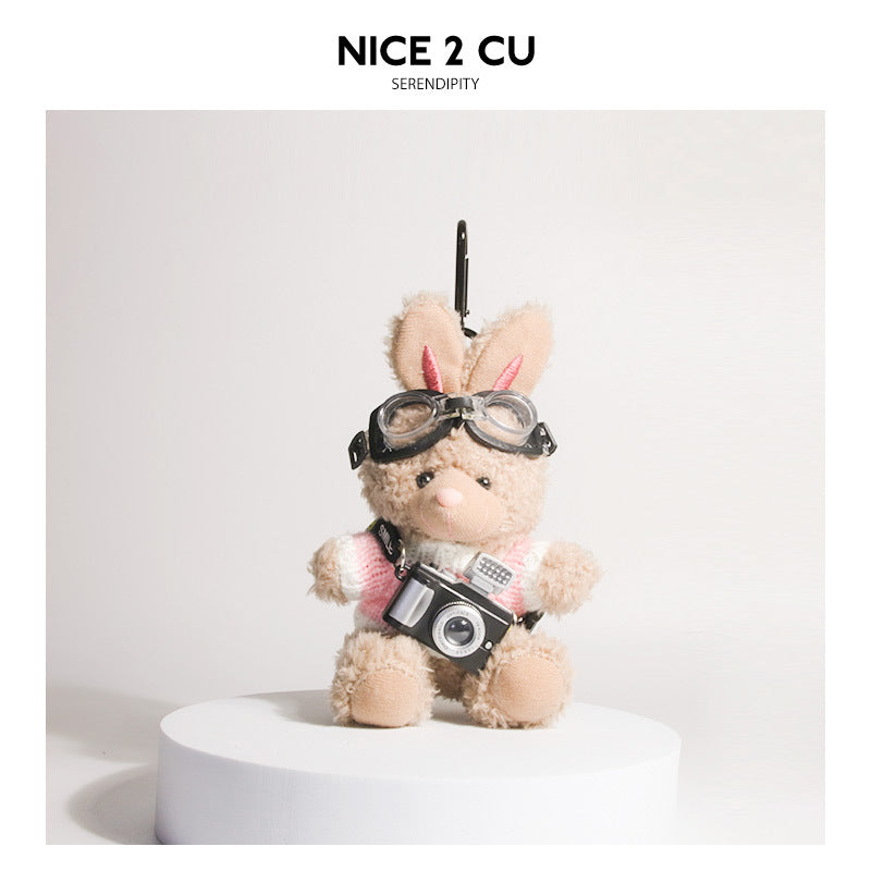 Brown plush rabbit keychain in pink-and-white knit sweater with aviator goggles and camera pendant