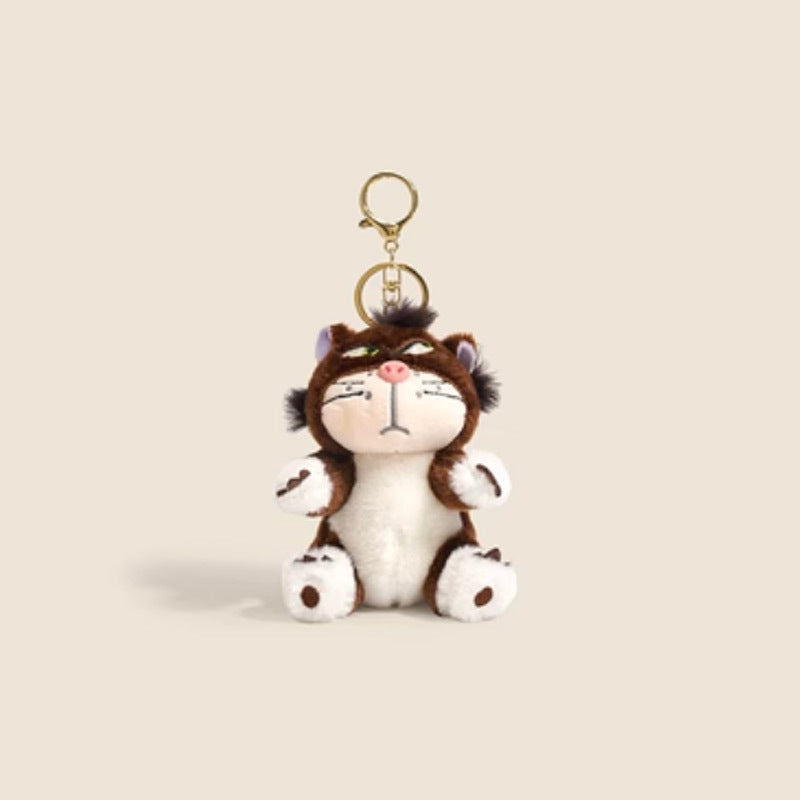 Brown and white grumpy cat plush keychain pendant with purple inner ears and gold lobster-claw clasp
