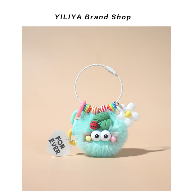 Mint green fluffy pom-pom keychain charm with colorful bead accents, ladybug leaf decoration, and white FOR EVER heart tag on