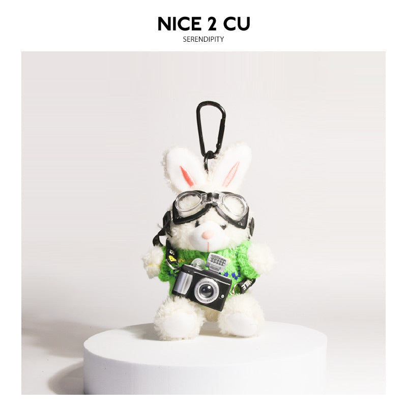 White plush rabbit keychain in green knit sweater with aviator goggles and miniature camera pendant