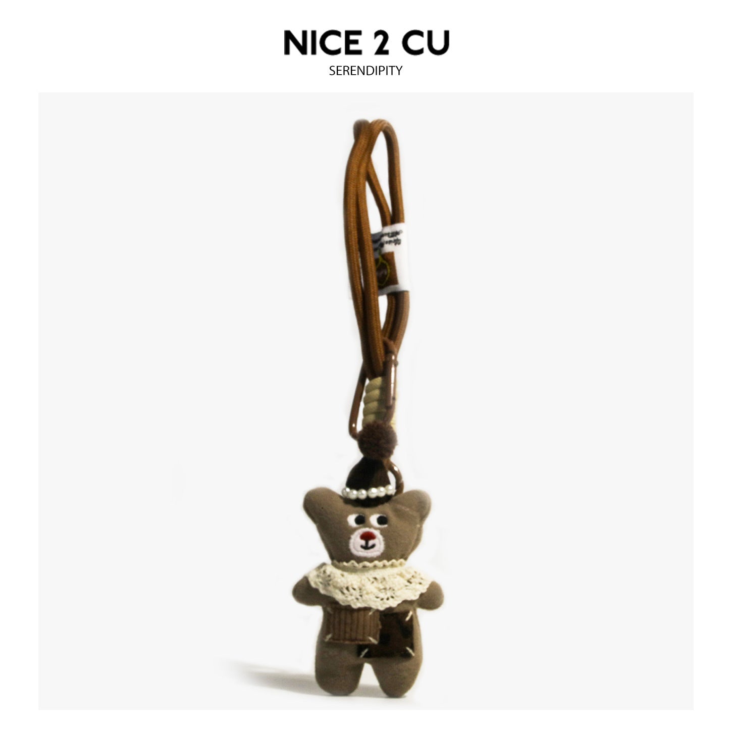 Coffee-brown plush bear bag charm with pearl-trimmed dark hat, cream crochet lace collar, and braided cord loop keychain