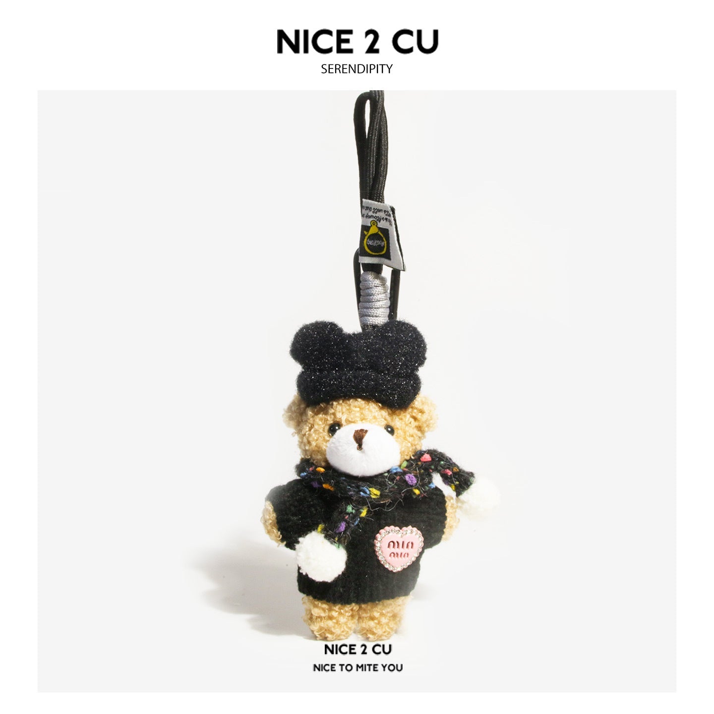 Plush teddy bear bag charm with black hat, dark outfit, and multicolor scarf hanging from a loop strap