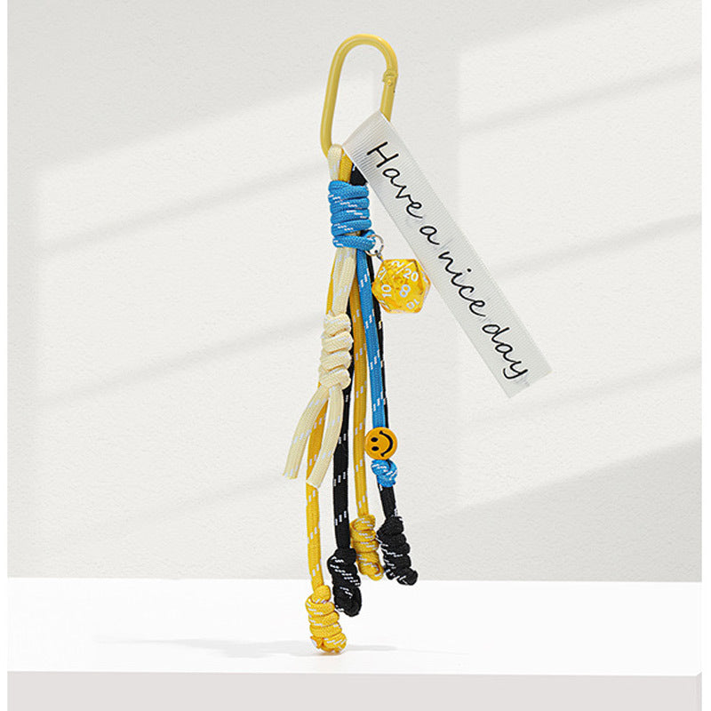 Yellow carabiner bag charm keychain with yellow and blue braided rope strands and Have a nice day woven tag