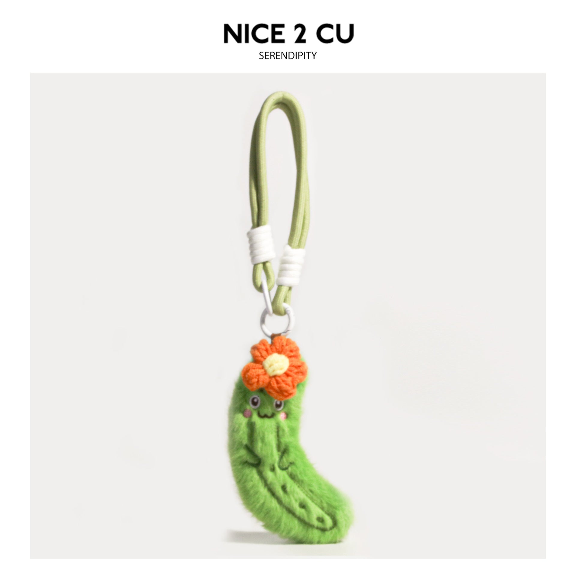 Kawaii cucumber plush keychain charm with orange crocheted flower accent and silver metal ring