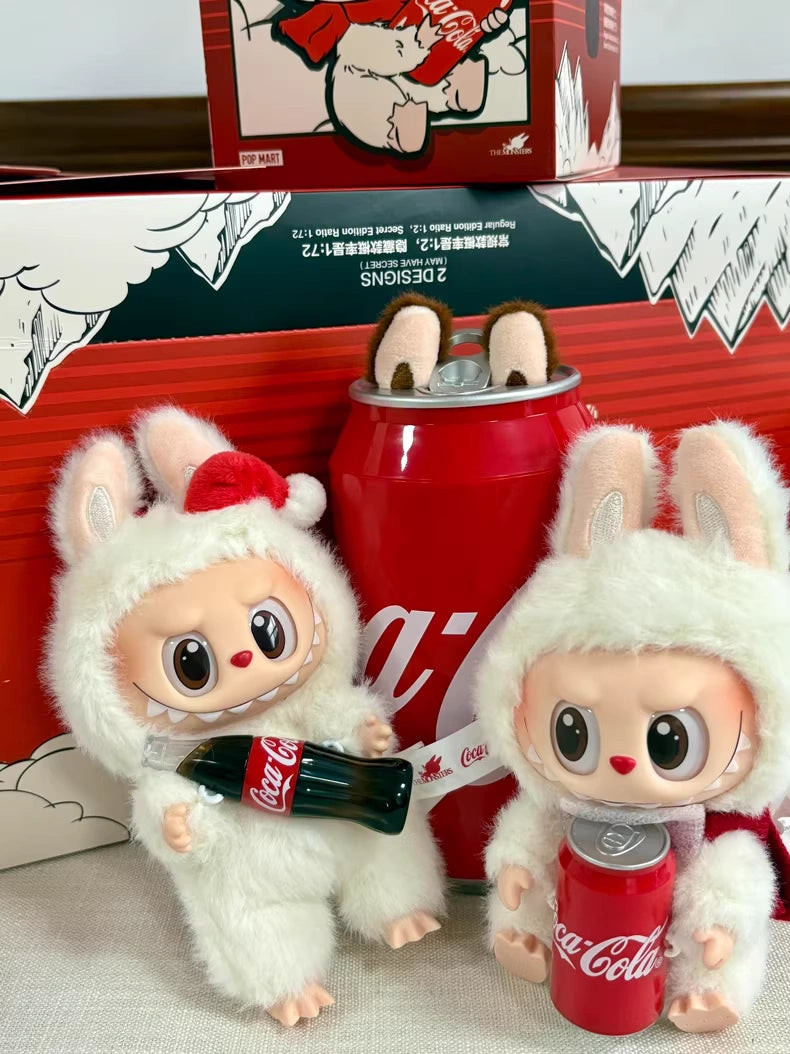 The Labubu Coca-Cola Surprise Shake Plush Keychain – Christmas Bunny Edition Vinyl Collectible by POP MART features two large-eyed bunny plush toys with mini Coca-Cola bottles—perfect as a festive collectible or keychain accessory.