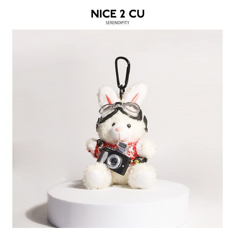 White plush rabbit keychain in red-and-white knit sweater with goggles and small camera pendant