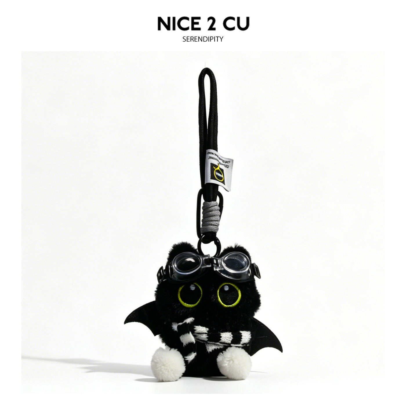 Black cat plush charm with bat wings, goggles, and black-and-white striped scarf on braided cord loop