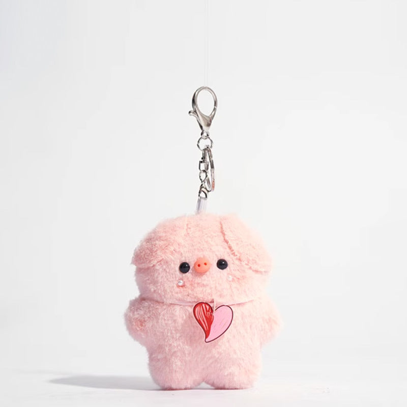 Pink plush pig keychain with a dangling heart pendant on chest, silver keychain hardware