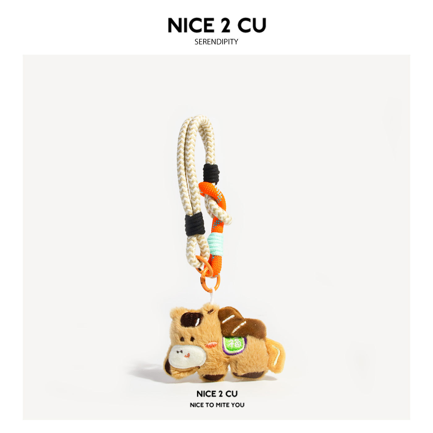 Beige and brown plush cow-style charm pendant with cream braided loop cord and orange accent patch