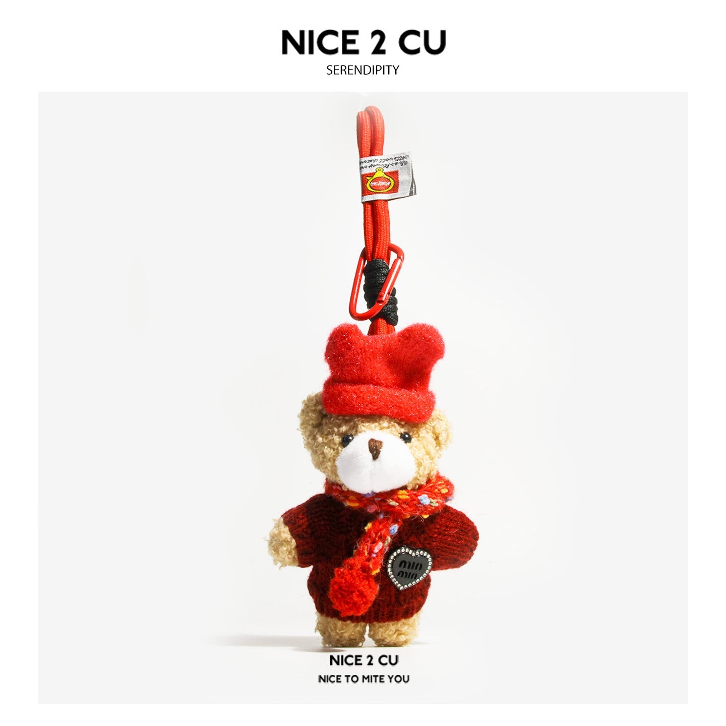 Miniature plush teddy bear keychain charm wearing a red fuzzy hat, dark red knitted sweater, and multicolor scarf with carabi