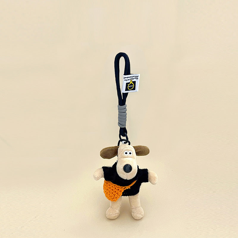 Cream cartoon dog plush keychain wearing black top and orange knit crossbody bag