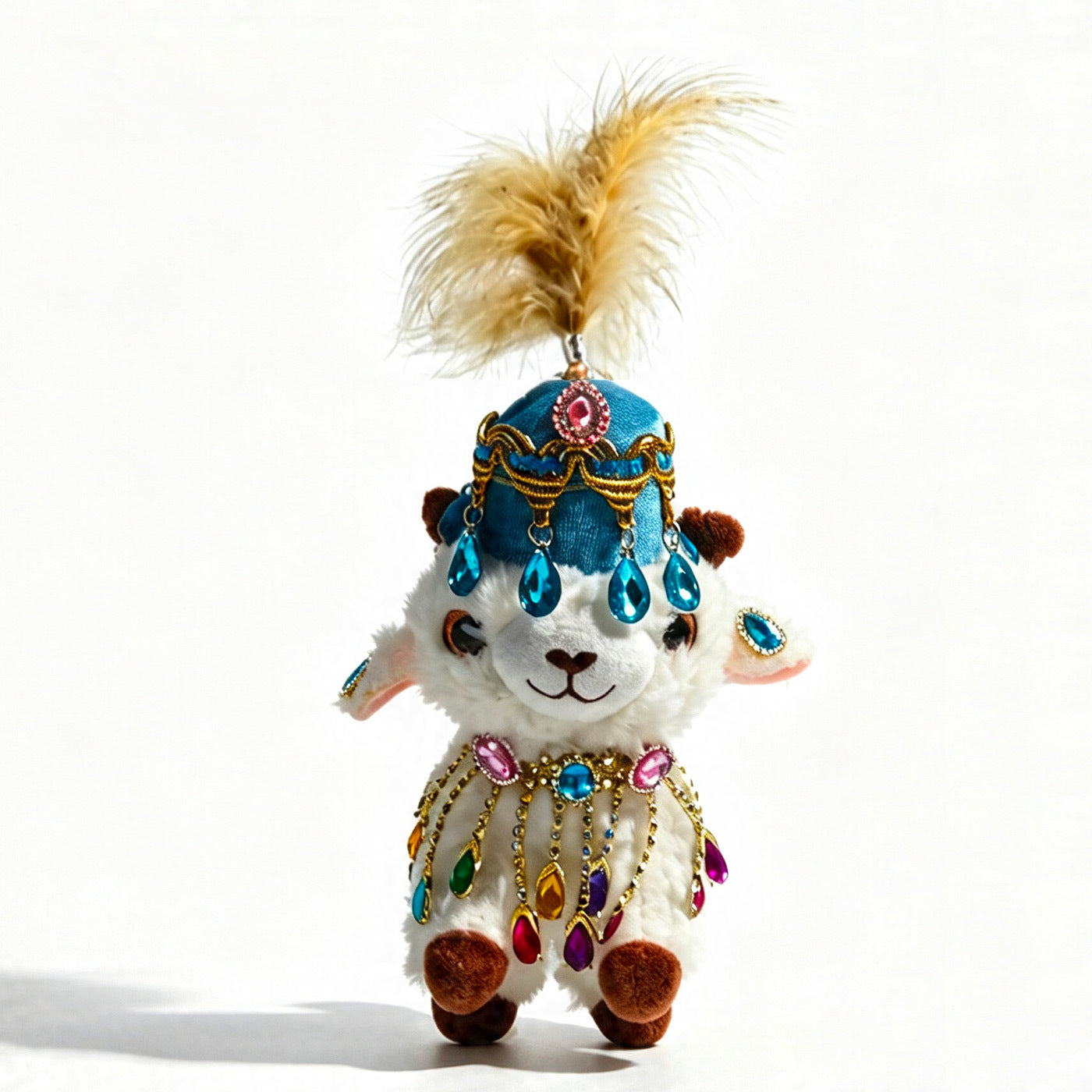Plush lamb figurine with deep blue feathered hat and white outfit with vertical blue-silver jewel drops