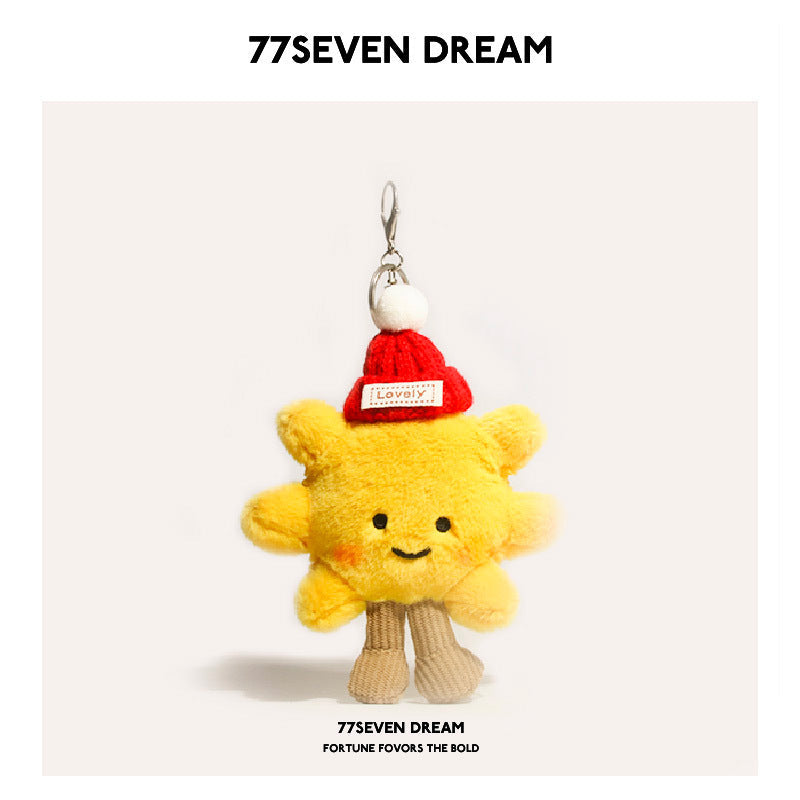Yellow sunflower plush charm wearing a red knit hat with white pom-pom and silver clip