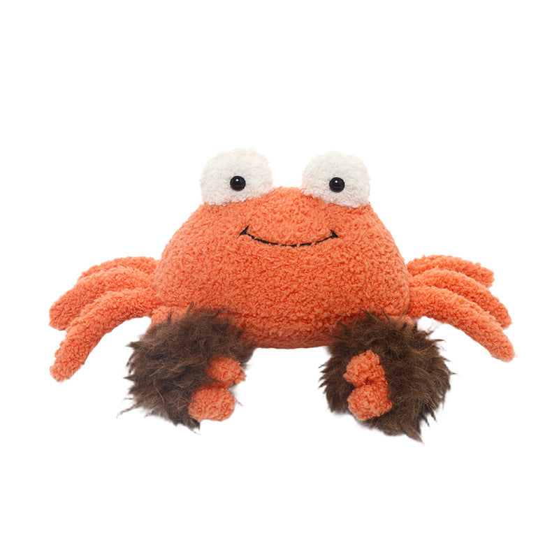 The JOOKI 23cm Orange Crab Plush Toy features a soft, smiling face, large white eyes, and fluffy brown claws—a cute sea animal plush perfect for marine life fans. Shown against a white background.