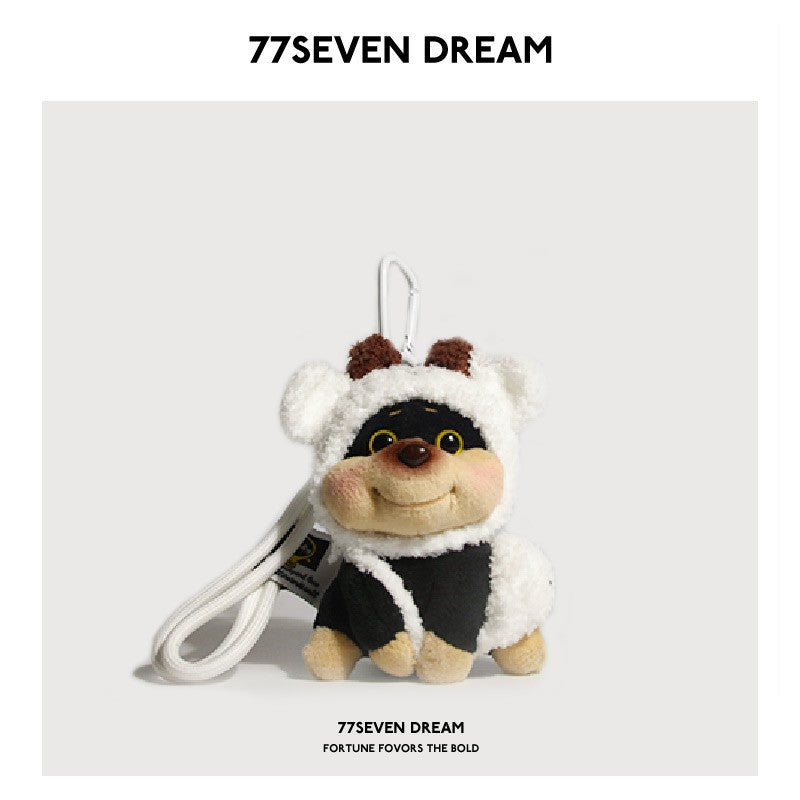 Chubby dog plush charm wearing a white sheep hood with brown horn details and a white hanging loop