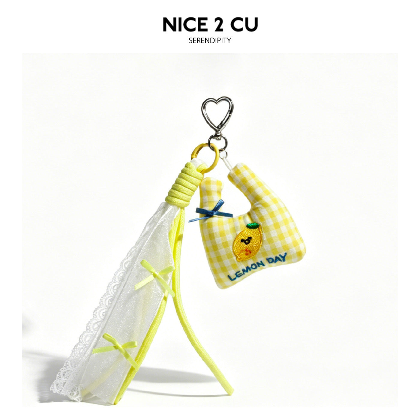 Yellow gingham mini bag charm with lemon applique and LEMON DAY text, sheer lace drape panel, and silver heart clip