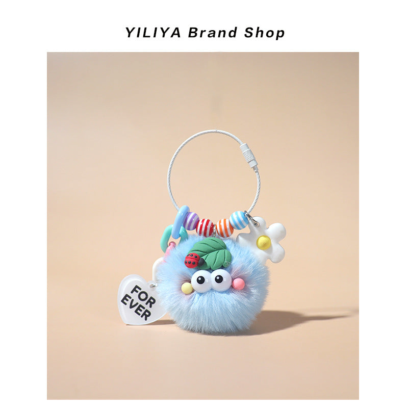 Light blue fluffy pom-pom keychain charm with rainbow bead arc, ladybug leaf decoration, and white FOR EVER heart tag on larg