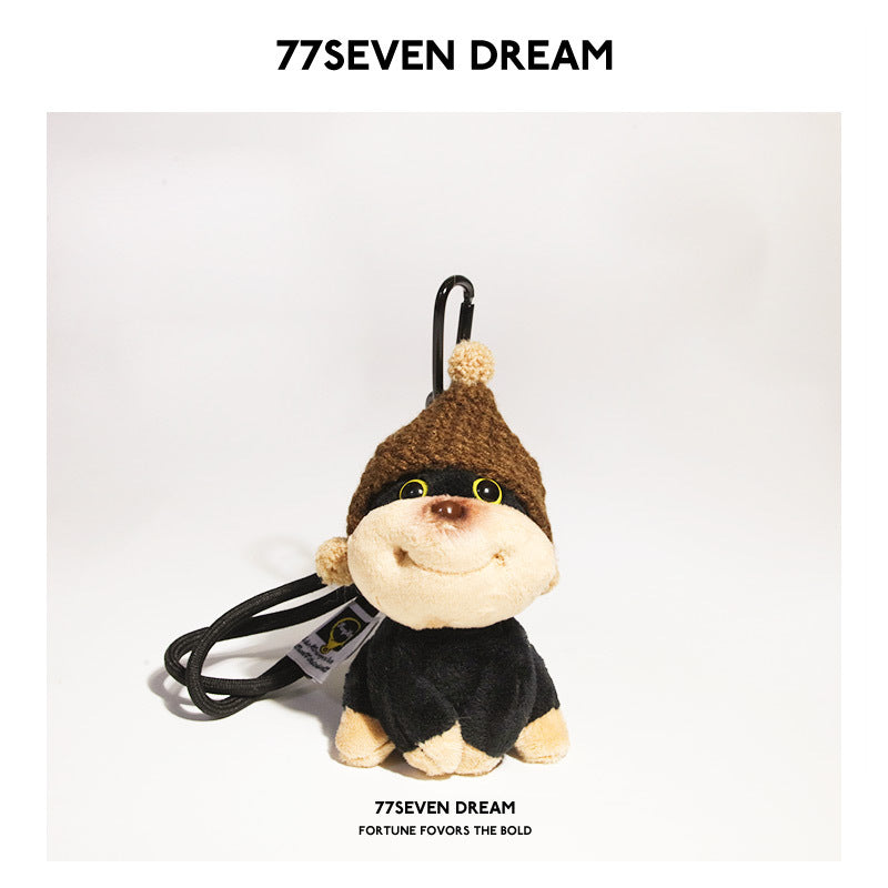 Chibi dog plush charm with dark brown knitted hat and hanging clip